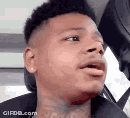 Man With Neck Tattoo Making Funny Face In Car GIF