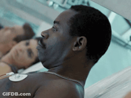 Man With Necklace Lying In Hospital Bed GIF