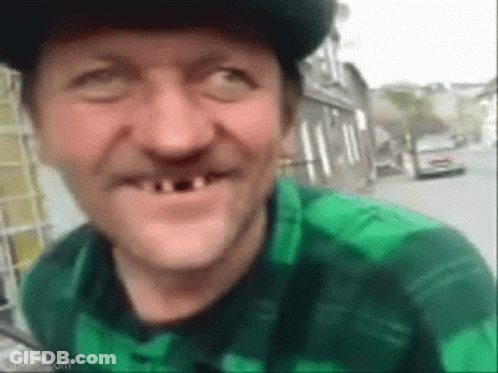 Man With No Teeth In Green Plaid Shirt And Hat Smiling GIF