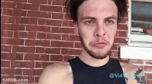 Man With Nose Ring At Brick Building GIF