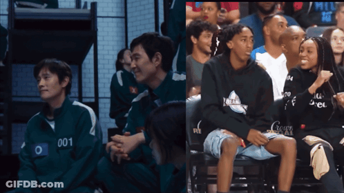 Man With Number 001 On Jacket Sits In Crowd GIF