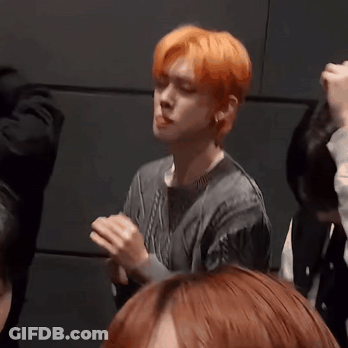 Man With Orange Hair Making Funny Face In Crowd GIF