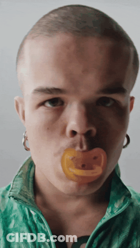 Man With Pacifier In Mouth Looking At Camera GIF