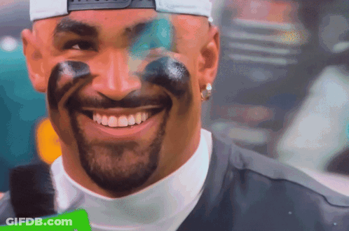 Man With Paint On Face Smiling In Baseball Cap GIF