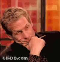 Man With Pen In Mouth Making Face GIF