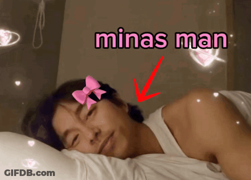 Man With Pink Bow Laying In Bed Saying Minas Man GIF