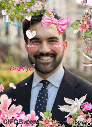 Man With Pink Bow Surrounded By Flowers GIF