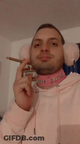 Man With Pink Ear Muffs And Choker Smoking GIF