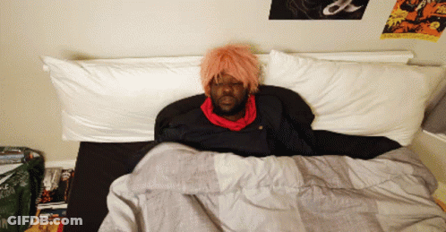 Man With Pink Hair Lying In Bed GIF