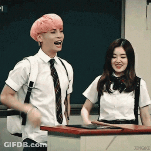 Man With Pink Hair Next To Woman In School Uniform GIF