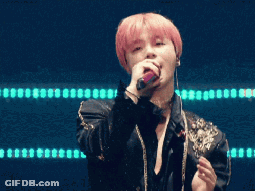 Man With Pink Hair Singing Into Microphone In Black Jacket And Choker GIF