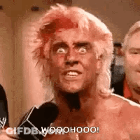Man With Pink Hair Talking Into Microphone GIF