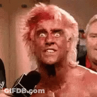 Man With Pink Hair Talking Into Microphone GIF