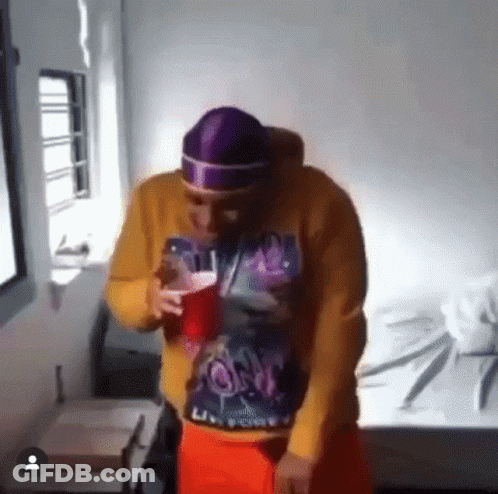 Man With Pink Scarf Around Head Holding Key GIF
