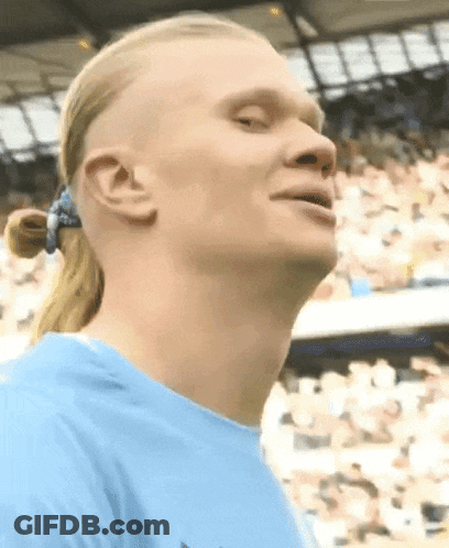Man With Ponytail And Blue Shirt Looking Up GIF