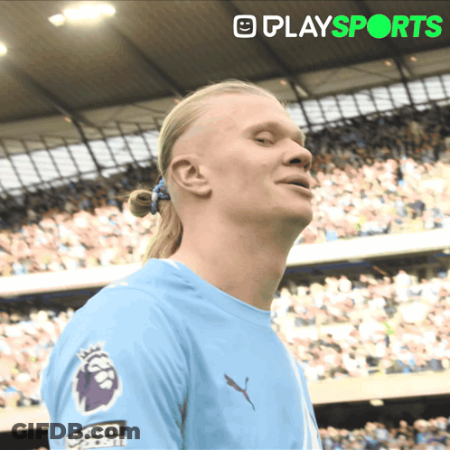 Man With Ponytail In Blue Shirt Saying Play Sports GIF