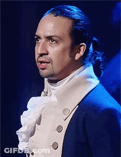 Man With Ponytail In Blue Suit And White Shirt GIF