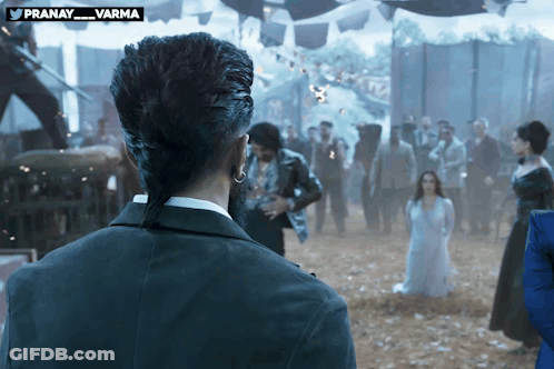 Man With Ponytail Standing In Front Of Crowd GIF