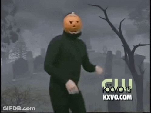 Man With Pumpkin Head Dancing In Front Of Cemetery GIF