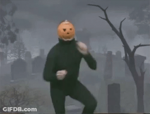 Man With Pumpkin Head In Cemetery GIF