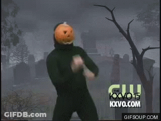 Man With Pumpkin On Head Dancing In Front Of Cemetery GIF