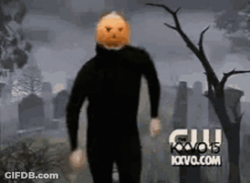 Man With Pumpkin On Head In Cemetery GIF
