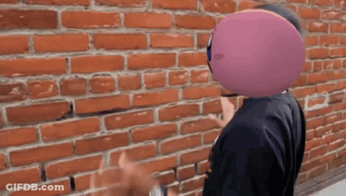 Man With Purple Balloon In Front Of Face GIF