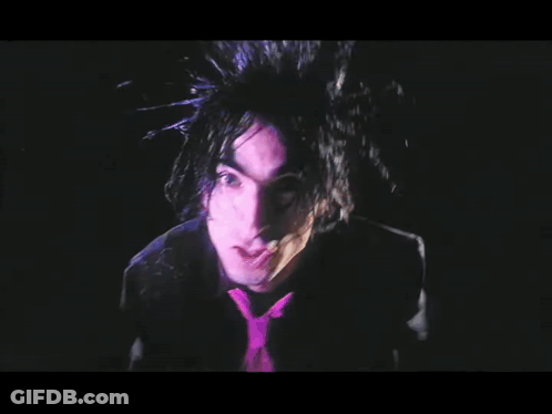 Man With Purple Hair And Tie In Dark GIF