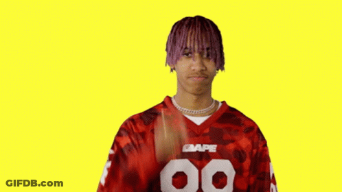 Man With Purple Hair Giving Peace Sign In Red BAPE Jersey GIF