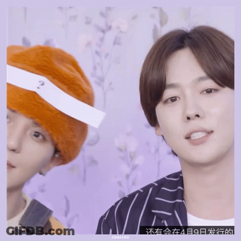 Man With Question Mark Headband Next To Another Man GIF