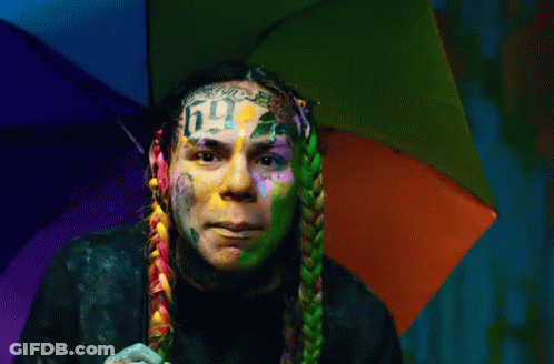 Man With Rainbow Umbrella On Head And Number 6 Face Tattoo GIF