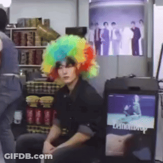 Man With Rainbow Wig Watching TV GIF