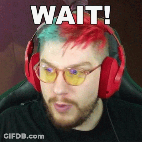 Man With Red And Green Hair In Headphones Saying Wait GIF