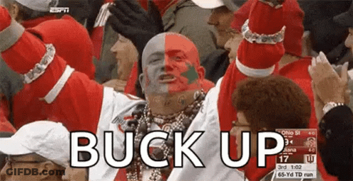 Man With Red And White Face Paint In Crowd Saying Buck Up GIF