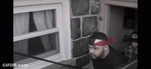 Man With Red Bandana Looking Out Window GIF