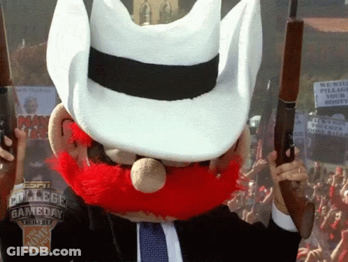 Man With Red Beard And White Hat Holding Two Guns GIF