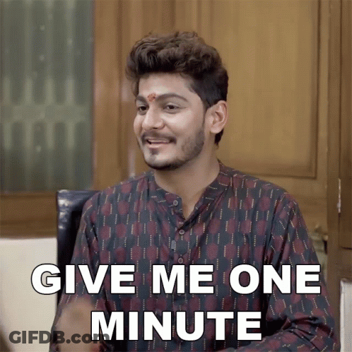 Man With Red Dot Saying Give Me One Minute GIF