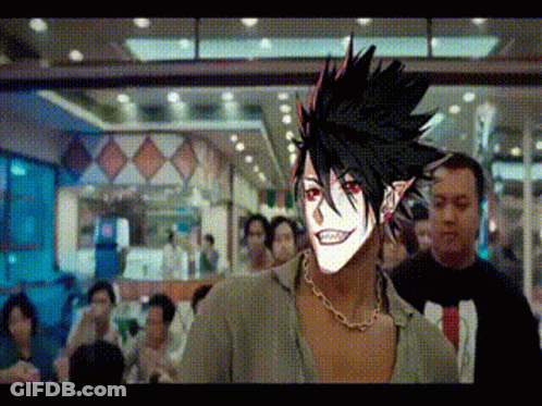 Man With Red Eyes And Necklace In Crowded Room GIF