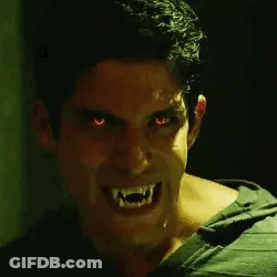 Man With Red Eyes And Vampire Teeth Smiling GIF