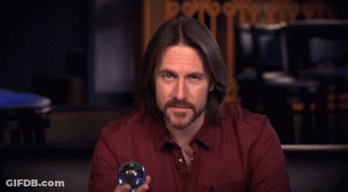 Man With Red Eyes Holding Blue Sphere GIF