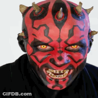 Man With Red Face Paint And Horns Smiling GIF