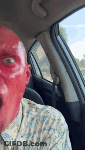 Man With Red Face Paint Sitting In Car GIF