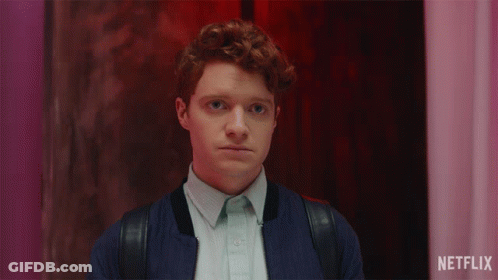 Man With Red Hair Smiling In Front Of Netflix Sign GIF