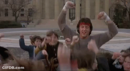 Man With Red Headband Surrounded By Crowd GIF