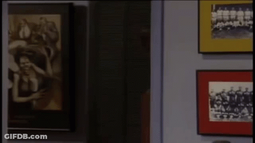 Man With Red Paint On Face By Picture Wall GIF