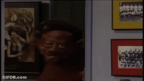 Man With Red Paint On Face Facing Picture Wall GIF