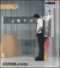 Man With Red Umbrella In Front Of Glass Door GIF