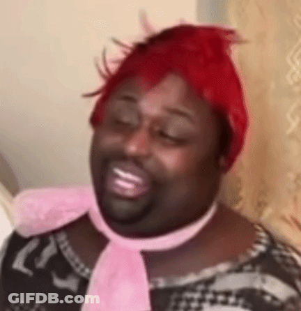 Man With Red Wig And Pink Scarf Smiling GIF