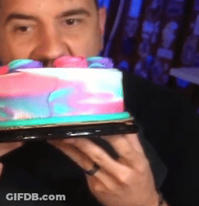 Man With Ring Holding Rainbow Cake GIF