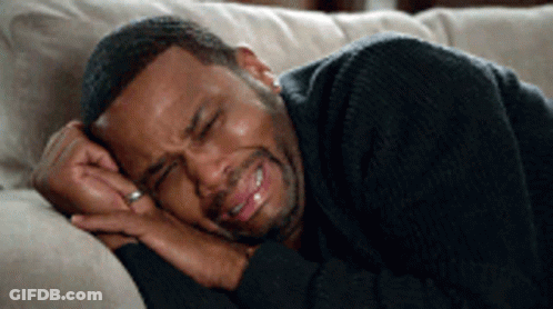Man With Ring Laying On Couch Eyes Closed GIF